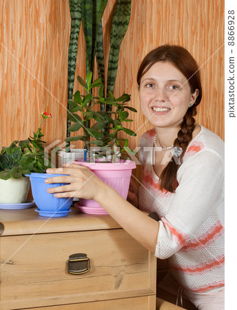woman with flowers in the pot 8866928