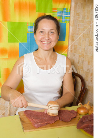 woman making meat tenderizer woman making meat tenderizer 8867850