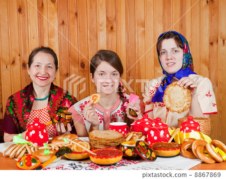 Women eating pancake during Shrovetide 8867869