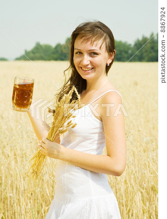 Girl with beer at cereals 8867924