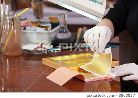 Iconographer gilding on the Christian icon 8868027