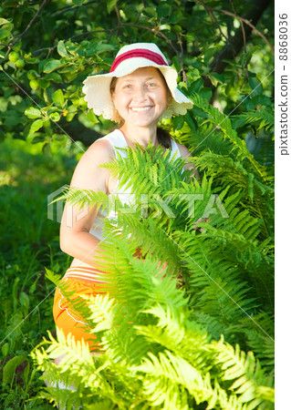 senior woman in yard gardening 8868036
