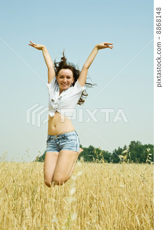 Jumping girl at field Jumping girl at field 8868148