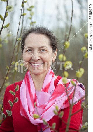 mature woman in spring pussywillow plant 8868929