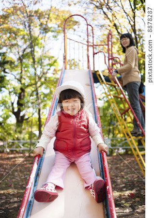 Parents and children playing on the slide Parents and children playing on the slide 8878287