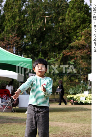 A boy flying a bamboo dragonfly A boy flying a bamboo dragonfly 8878600