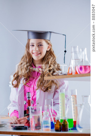 Cheerful excellent student posing in chemistry lab