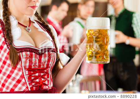 Young people in traditional Bavarian Tracht in restaurant or pub Young people in traditional Bavarian Tracht in restaurant or pub 8890228
