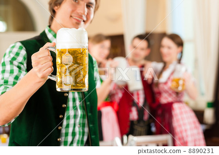 Young people in traditional Bavarian Tracht in restaurant or pub Young people in traditional Bavarian Tracht in restaurant or pub 8890231