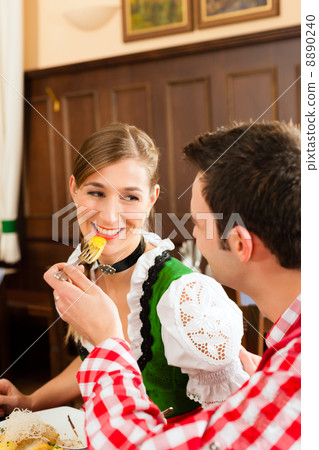 People in traditional Bavarian Tracht eating in restaurant or pub People in traditional Bavarian Tracht eating in restaurant or pub 8890240