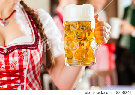 Young people in traditional Bavarian Tracht in restaurant or pub Young people in traditional Bavarian Tracht in restaurant or pub 8890241