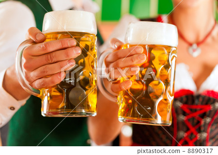 Man and woman with beer glass in brewery 8890317