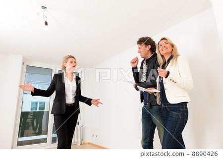 Young couple looking for real estate with female realtor Young couple looking for real estate with female realtor 8890426