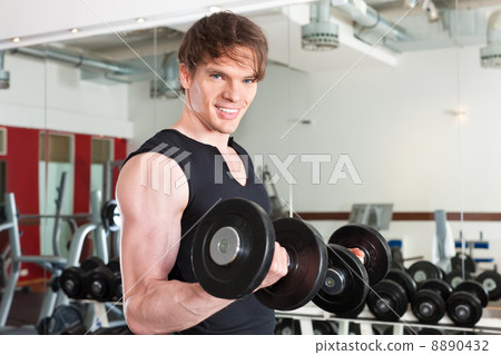 Sport - man is exercising with barbell in gym 8890432