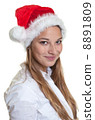 Portrait of a smiling woman with christmas hat 8891809