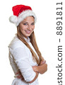 Smiling woman with christmas hat and crossed arms 8891811