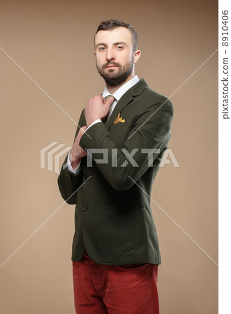 young man in a green suit and tie 8910406