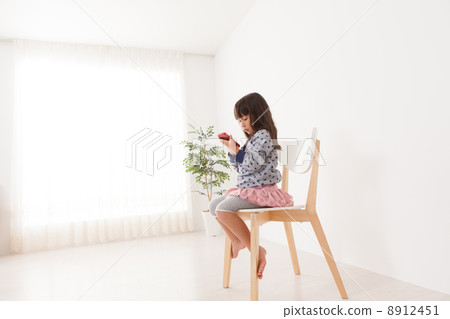 A 5 year old girl playing with a smartphone 8912451