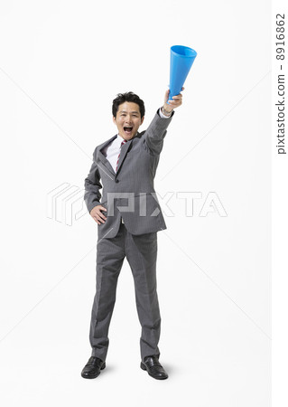 A businessman standing with a megaphone A businessman standing with a megaphone 8916862