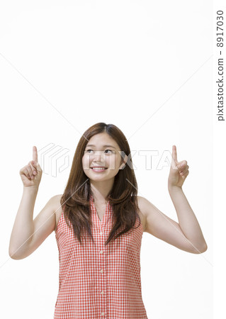 A woman standing with her finger 8917030
