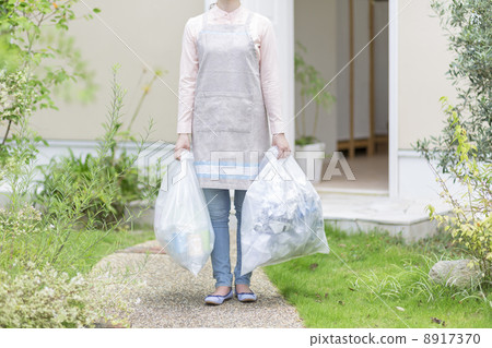 Woman putting out garbage 8917370