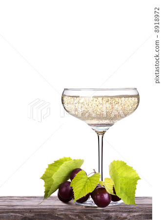 grapes with glass of champagne on a table grapes with glass of champagne on a table 8918972