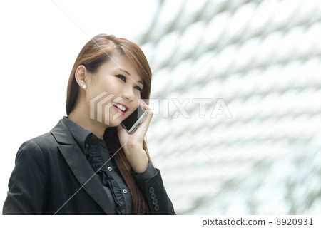 Young pretty businesswoman using mobile phone Young pretty businesswoman using mobile phone 8920931
