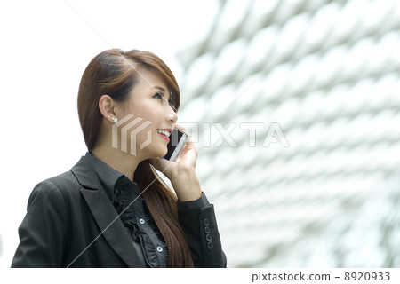 Young pretty businesswoman using mobile phone Young pretty businesswoman using mobile phone 8920933
