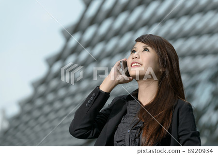 Young pretty businesswoman using mobile phone Young pretty businesswoman using mobile phone 8920934