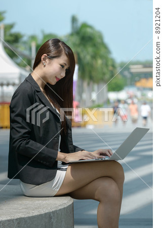 Young office lady using laptop long promenade Young office lady using laptop long promenade 8921204