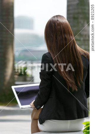 Young office lady using laptop long promenade Young office lady using laptop long promenade 8921205