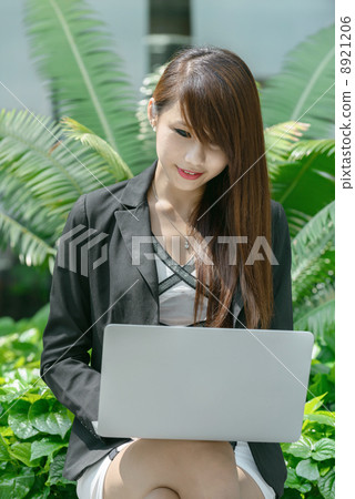 Young office lady using laptop long promenade  8921206