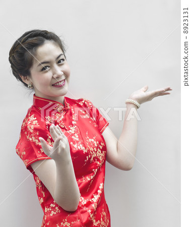 Asian Chinese woman in Traditional Chinese Cheongsam gesturing Asian Chinese woman in Traditional Chinese Cheongsam gesturing 8923131