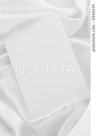 White card on white satin White card on white satin 8948334