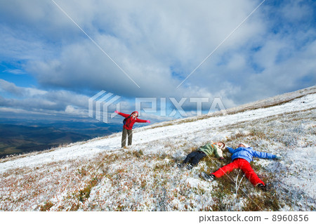 Family on autumn mountain plateau first winter snow Family on autumn mountain plateau first winter snow 8960856