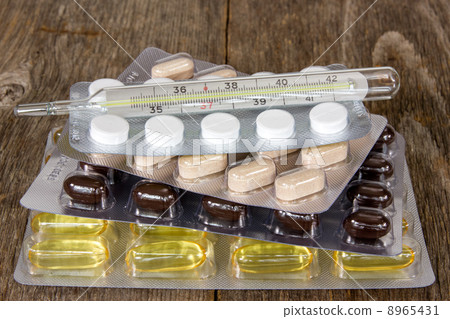 Thermometer and various pills Thermometer and various pills 8965431