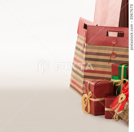 Pillar of boxes with presents wrapped in red paper on white back 8967678