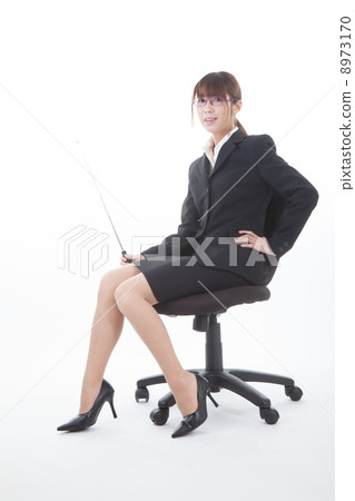 A woman sitting in an office chair A woman sitting in an office chair 8973170