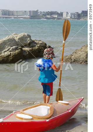 Child with sea kayak and paddle for children 8973949