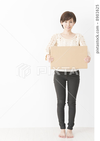A woman with a cardboard box A woman with a cardboard box 8981625