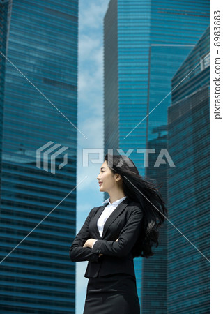 Young Office Lady in front of glass office building 8983883
