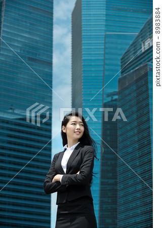 Young Office Lady in front of glass office building Young Office Lady in front of glass office building 8983884