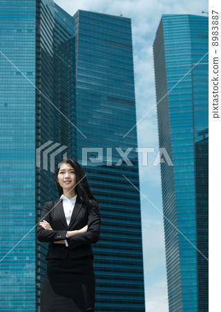Young Office Lady in front of glass office building Young Office Lady in front of glass office building 8983887