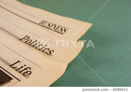old newspaper on a green background old newspaper on a green background 8986631