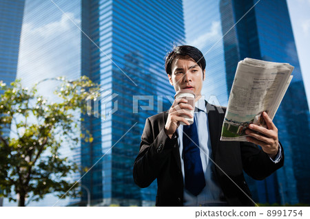 Businessman in the City reading Papers Businessman in the City reading Papers 8991754