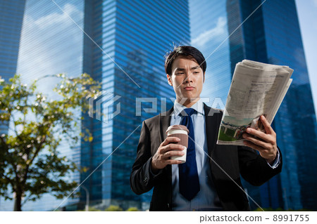 Businessman in the City reading Papers Businessman in the City reading Papers 8991755