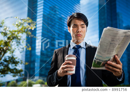 Businessman in the City reading Papers 8991756