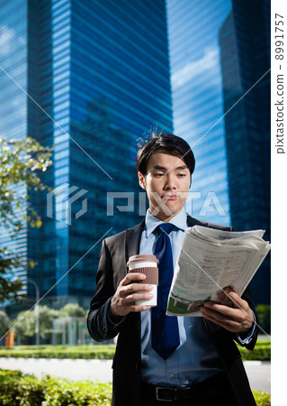 Businessman in the City reading Papers Businessman in the City reading Papers 8991757