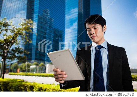 Businessman in the City using iPad Businessman in the City using iPad 8991758