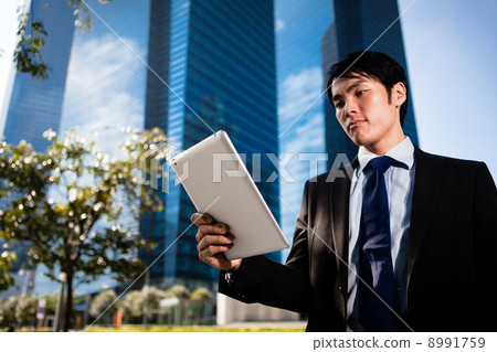 Businessman in the City using iPad Businessman in the City using iPad 8991759